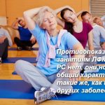 a group of people sitting tilt their heads with their hands